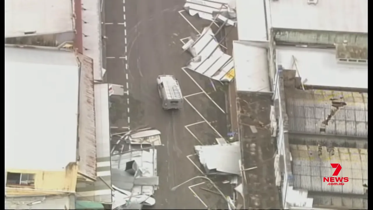 Aerial view of a town centre with roofs ripped off and debris in the streets