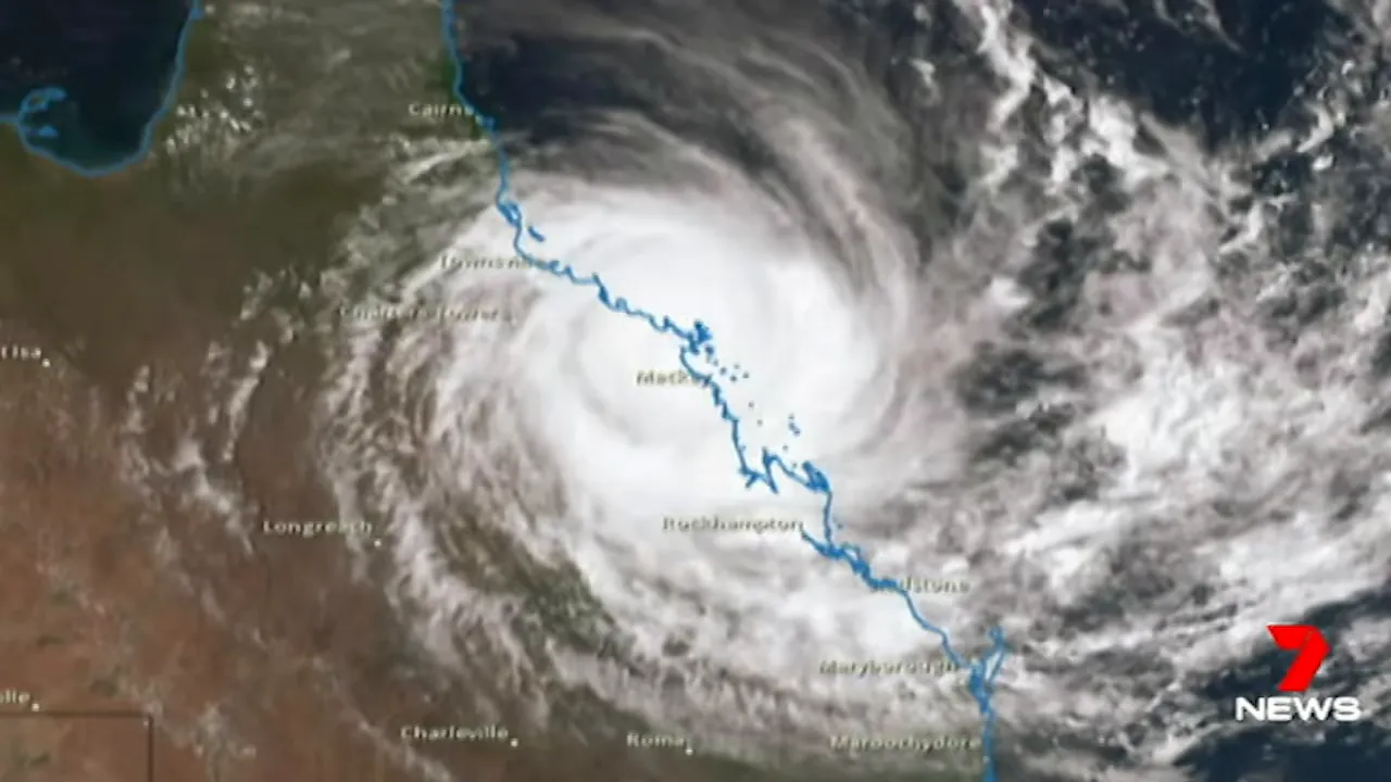 Satellite image of a tropical cyclone with a clear eye and spiral cloud bands over a coastline