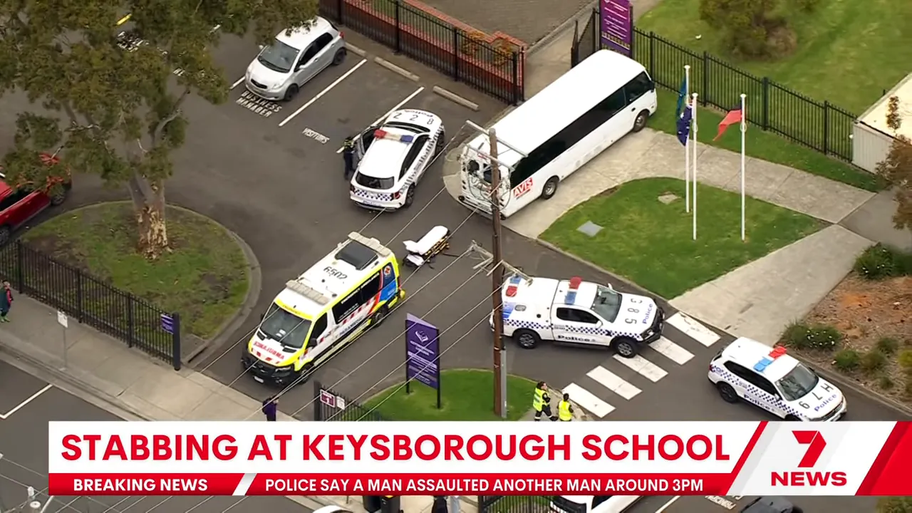 Aerial shot showing an ambulance, police vehicles and a stretcher at Keysborough Secondary College entrance.
