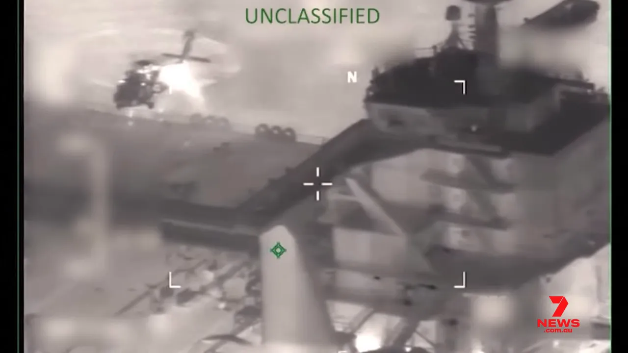 clear infrared view of helicopter approaching oil tanker deck with UNCLASSIFIED text