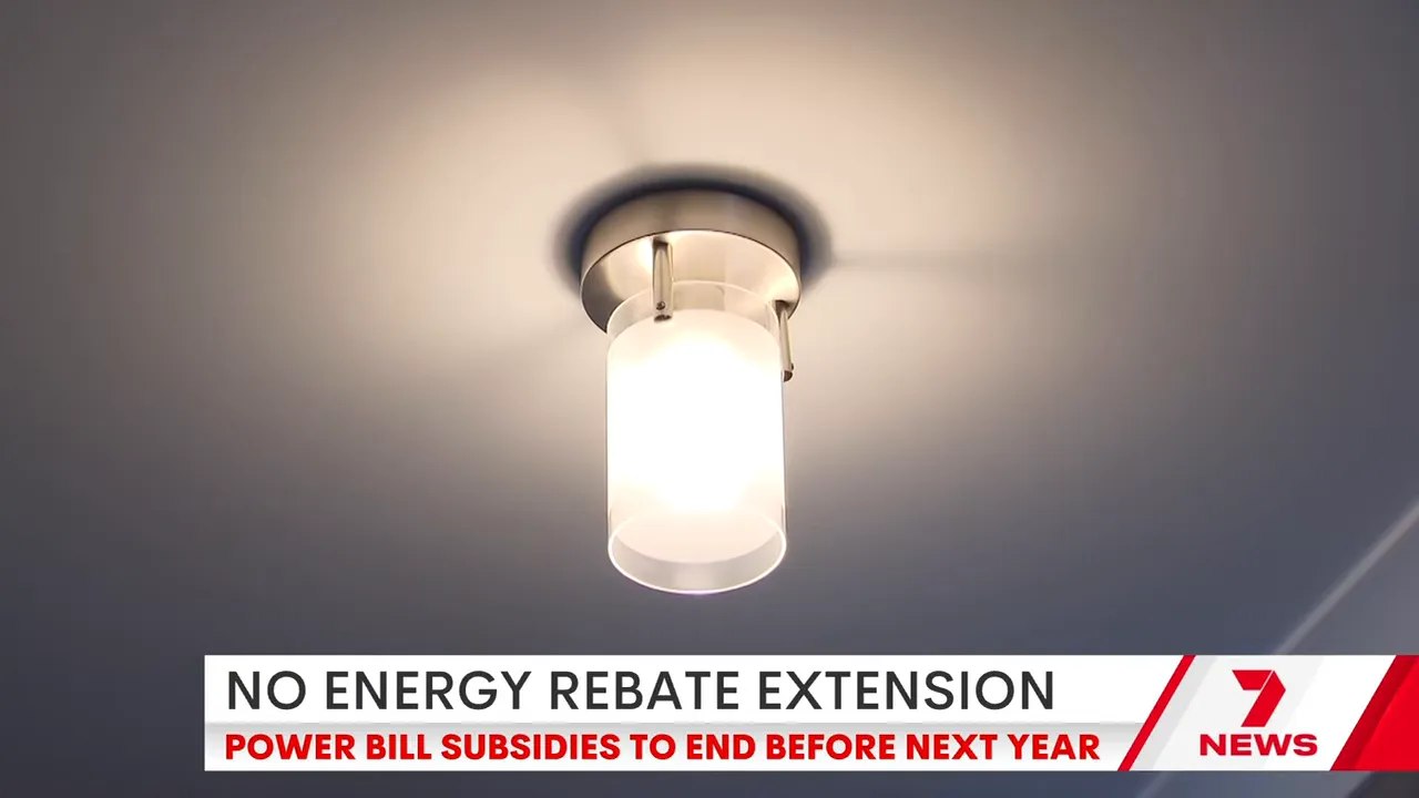 Ceiling light fixture illuminated with news banner reading 'No energy rebate extension'