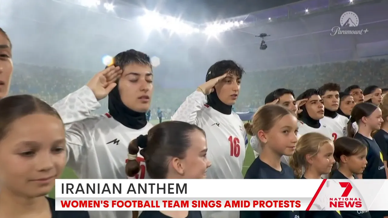 Iranian women's football team standing and saluting during the national anthem at Cbus Stadium, Gold Coast.