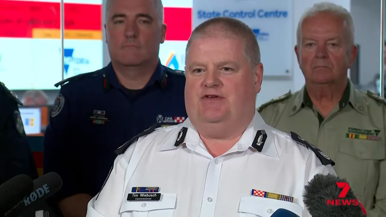Senior emergency services official delivering a public safety briefing at the operations centre