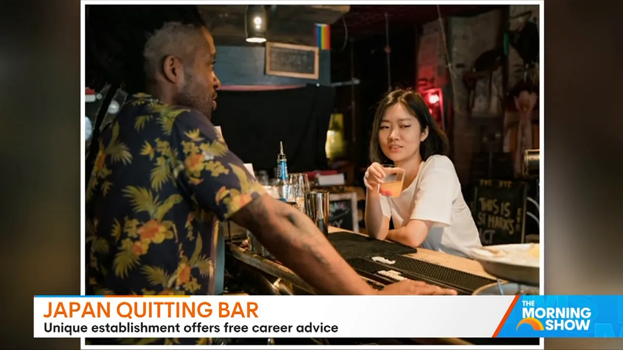 Bar staff and a visitor conversing across the counter while the visitor holds a drink.