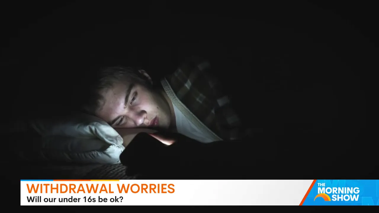 Teen lying in bed scrolling phone in the dark, illustrating late-night screen use