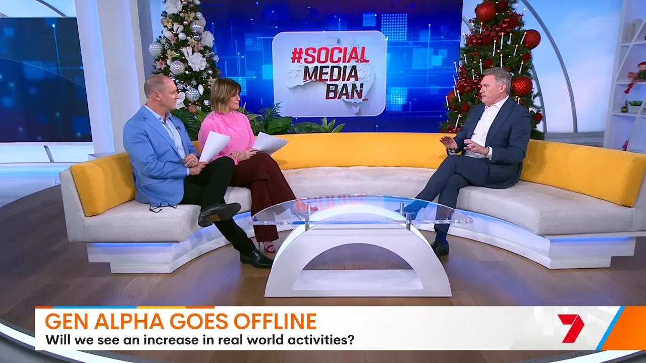 Three presenters on a curved sofa with '#Social Media Ban' logo on the screen behind them