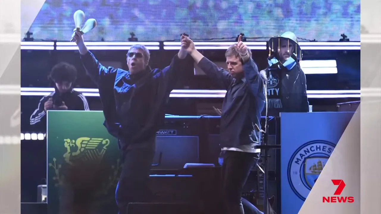 Gallagher brothers fist bump on stage