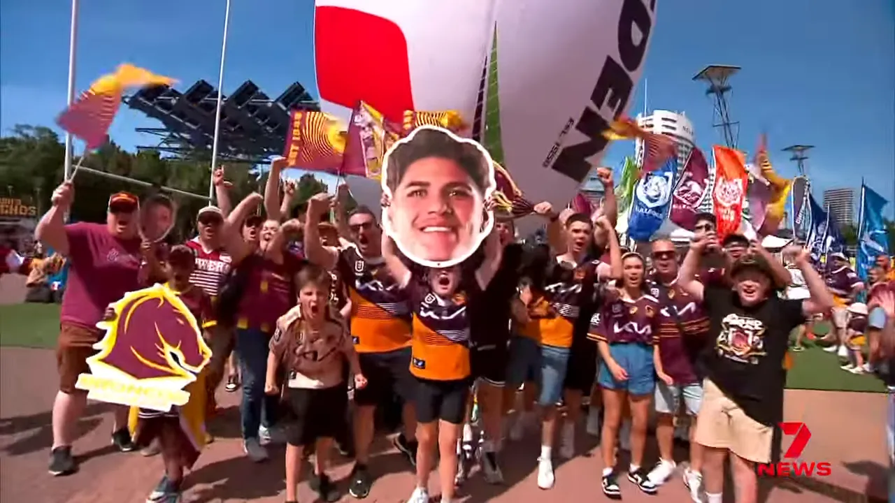 Fans waving flags and cheering at Olympic Park