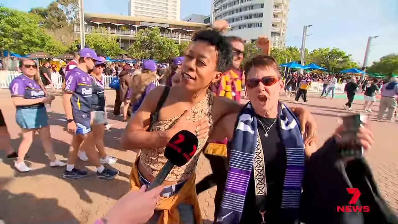 Broncos fans chanting and waving flags at Olympic Park