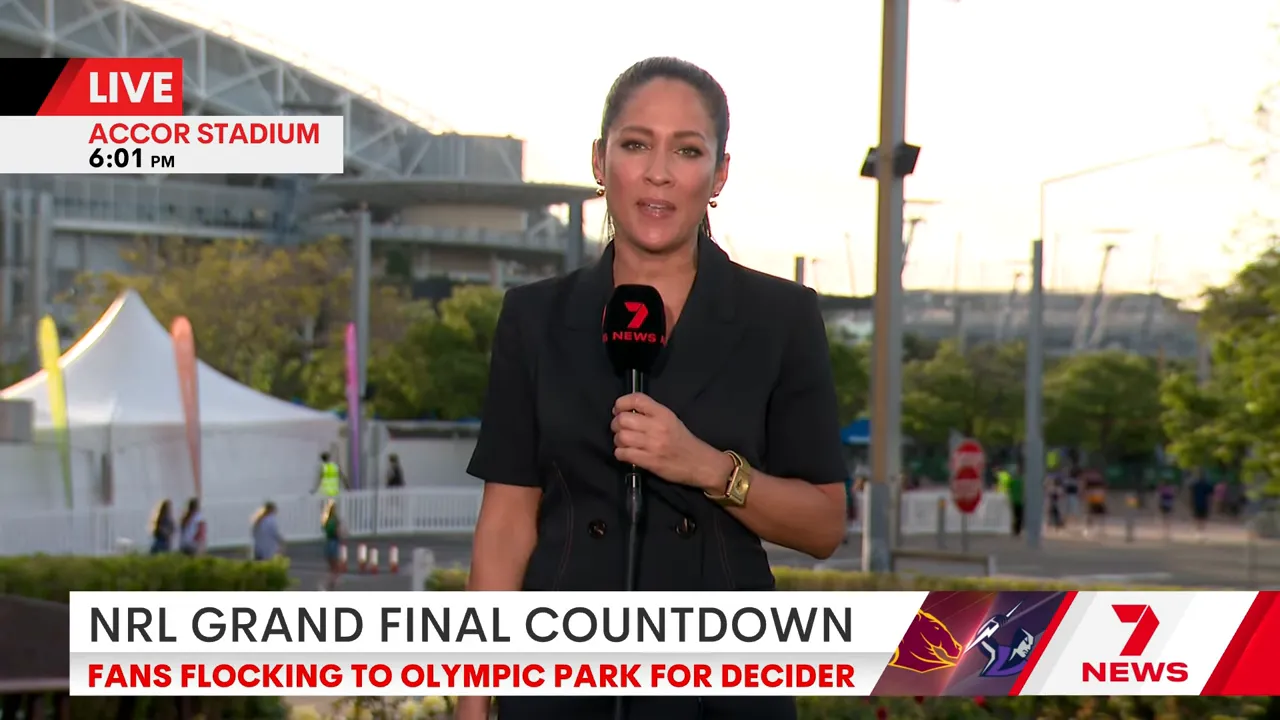 Crowd entering stadium with clear skies