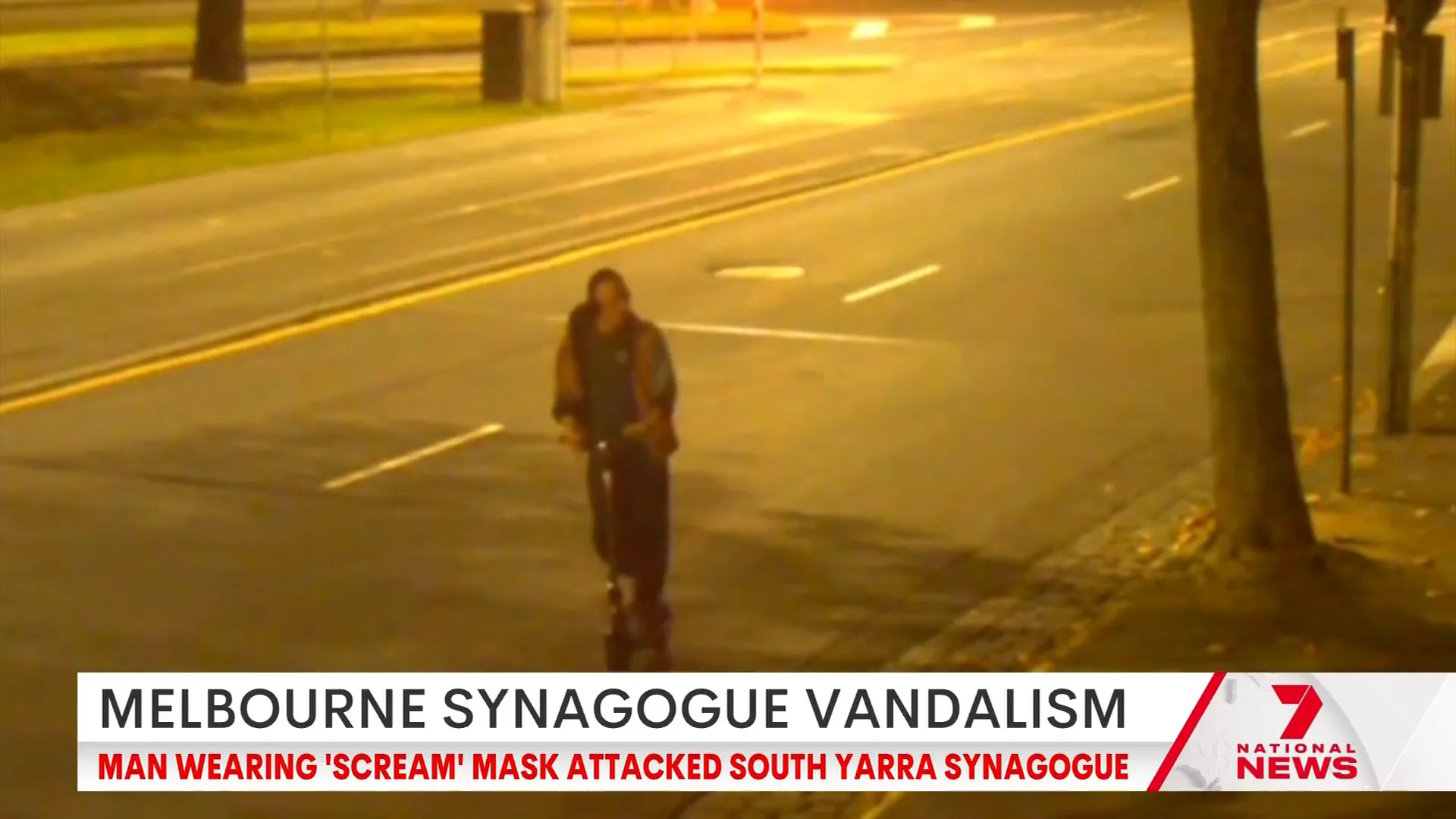 Vandal wearing Scream mask and black jacket on scooter