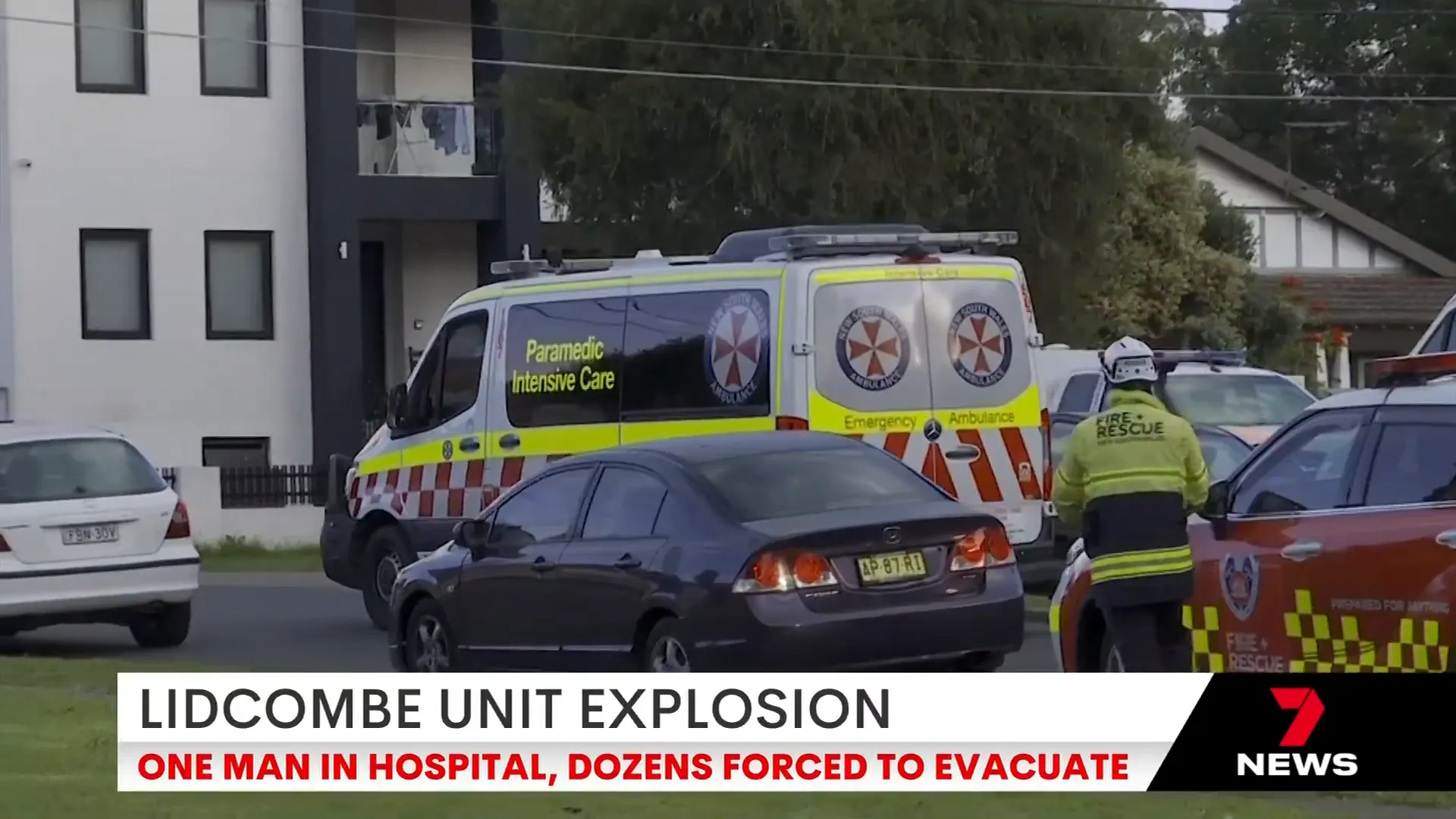 Paramedics attending to residents outside the apartment complex