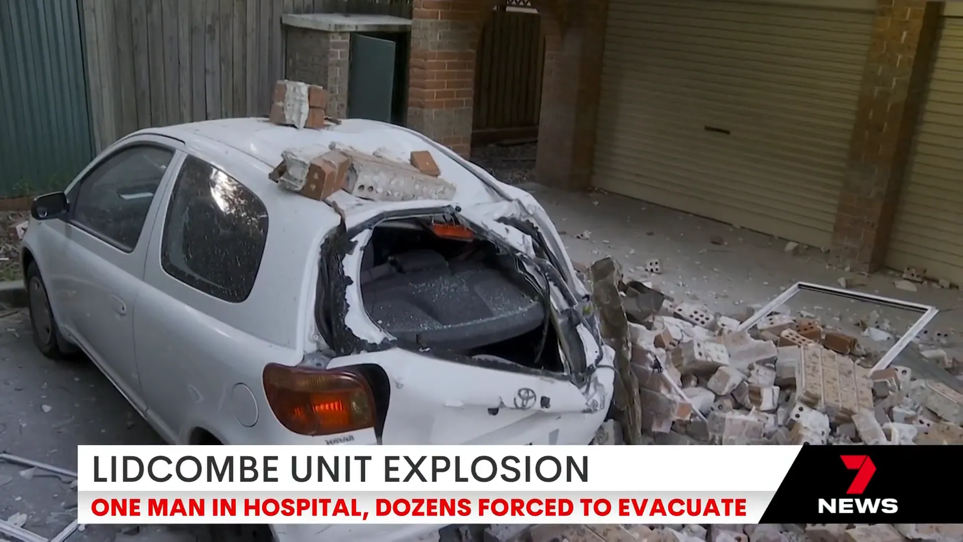Debris scattered across the car park with a crushed vehicle visible