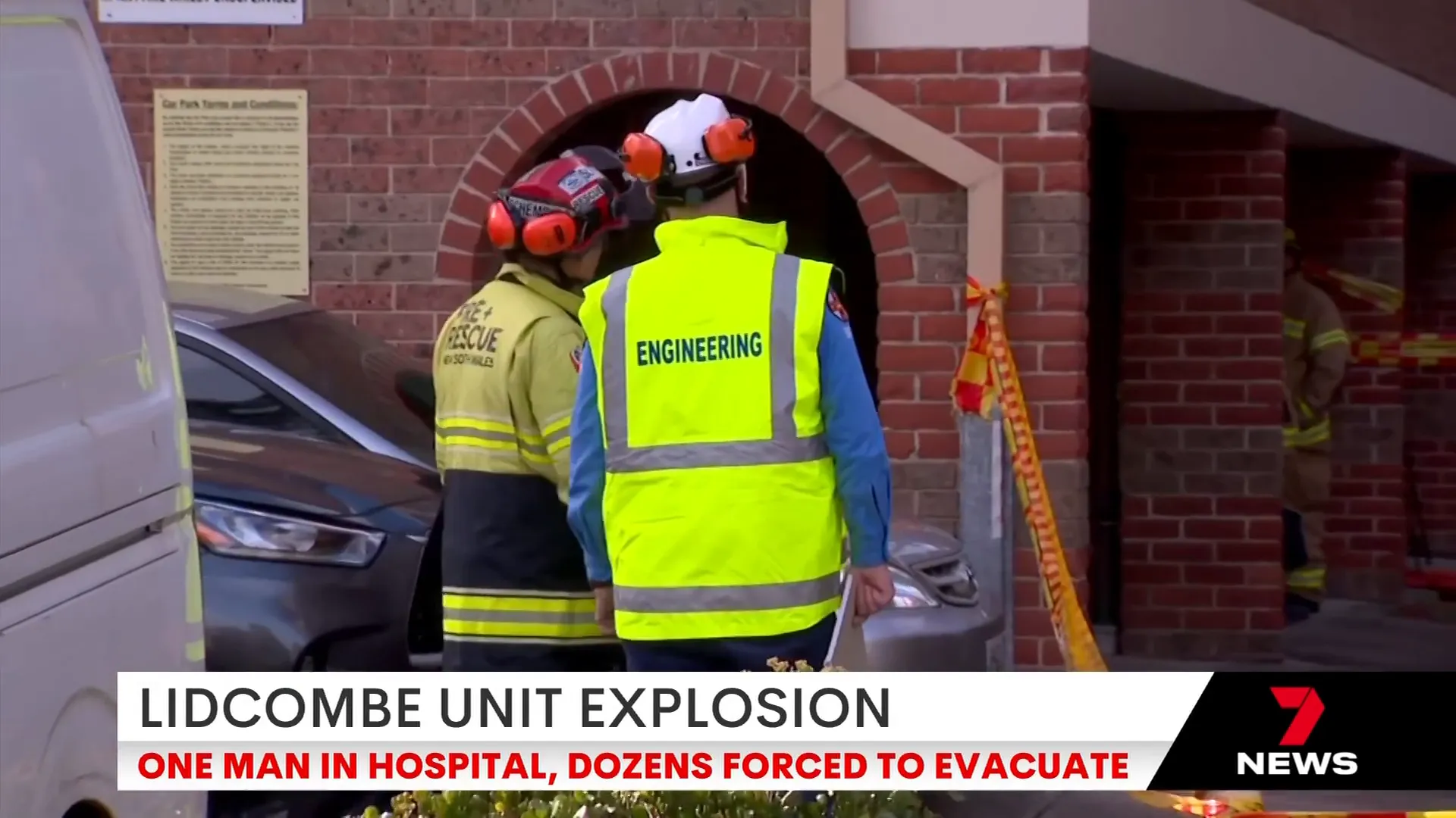 Engineers inspecting the damaged apartment block walls