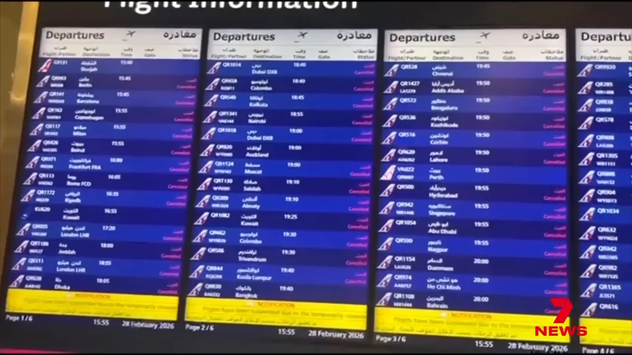 Airport departures board listing flights with many entries marked cancelled or delayed