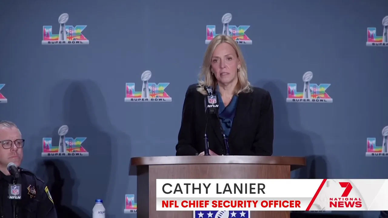 Security official speaking at a podium with NFL branding during a press conference on stadium enforcement.