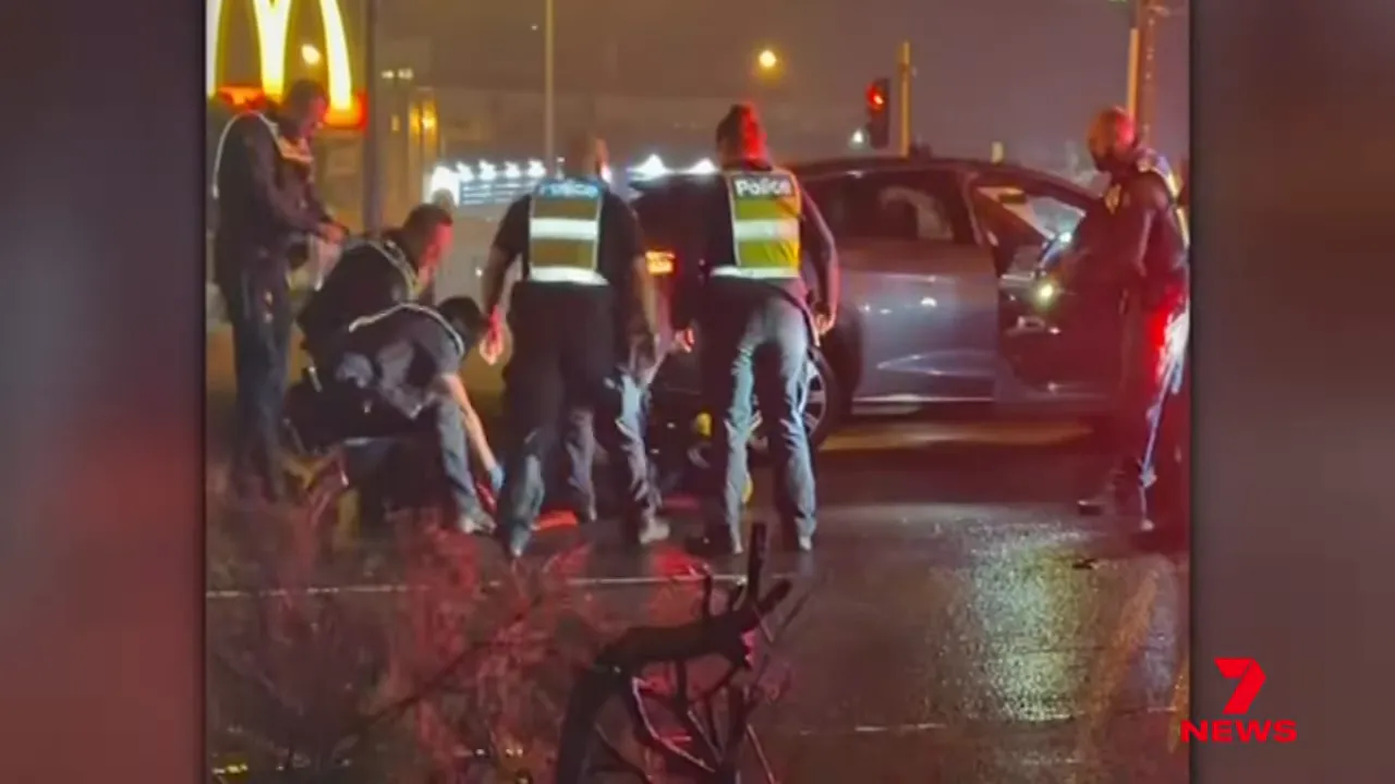 Officers drag the man from the car after several minutes