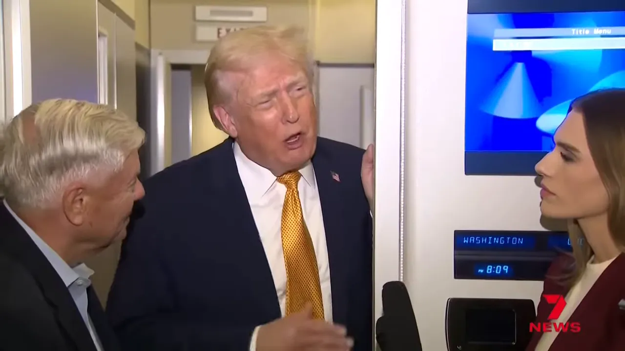 Man mid-speech responding to reporters inside an airplane corridor with a microphone visible