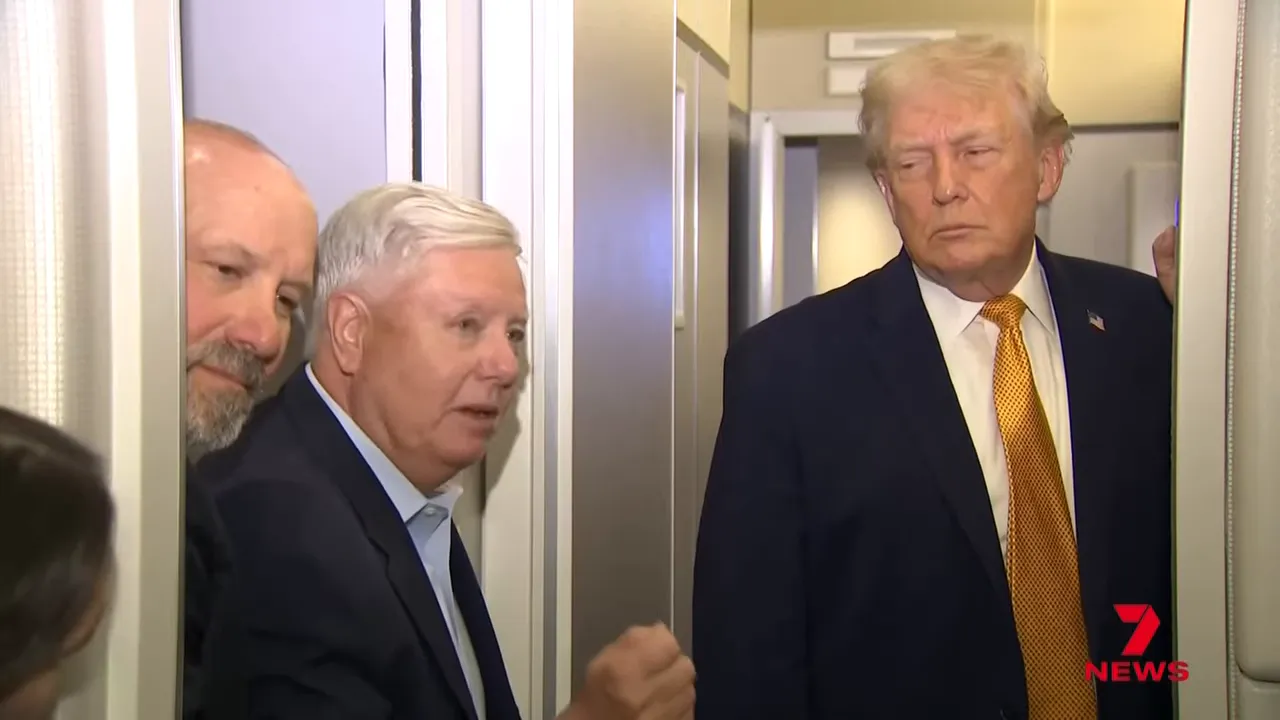 Group of men in suits in an aircraft cabin during a televised briefing