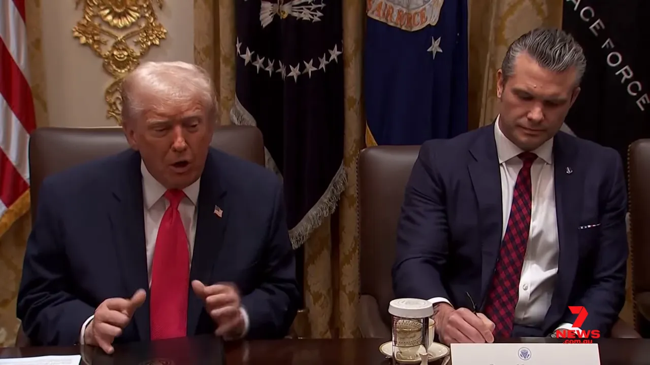President speaking and gesturing at a cabinet table as a senior official writes notes