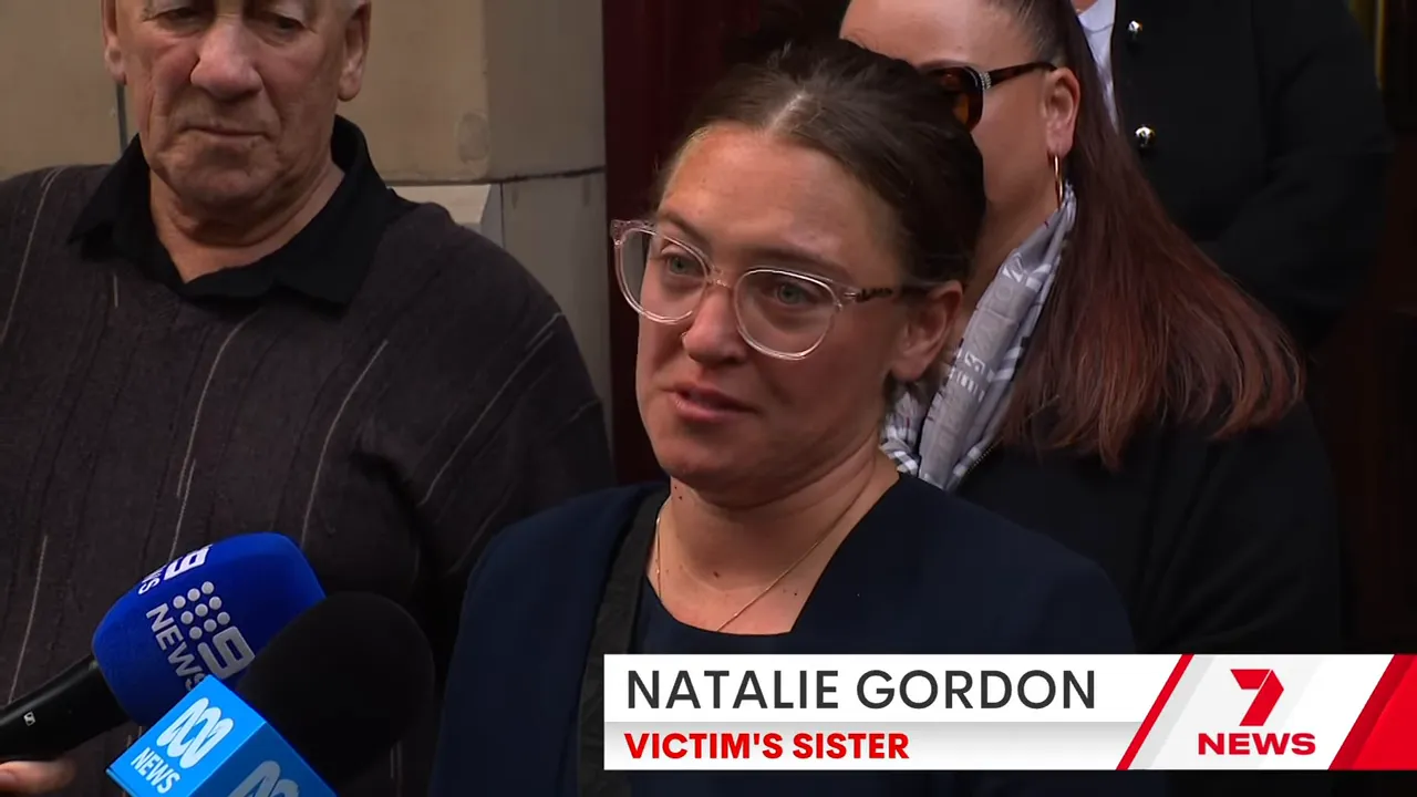 Family member speaking to journalists outside the courthouse with visible emotion and microphones.