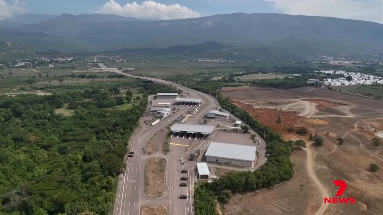 Aerial photograph of a border crossing and checkpoint with nearby roads and vehicles