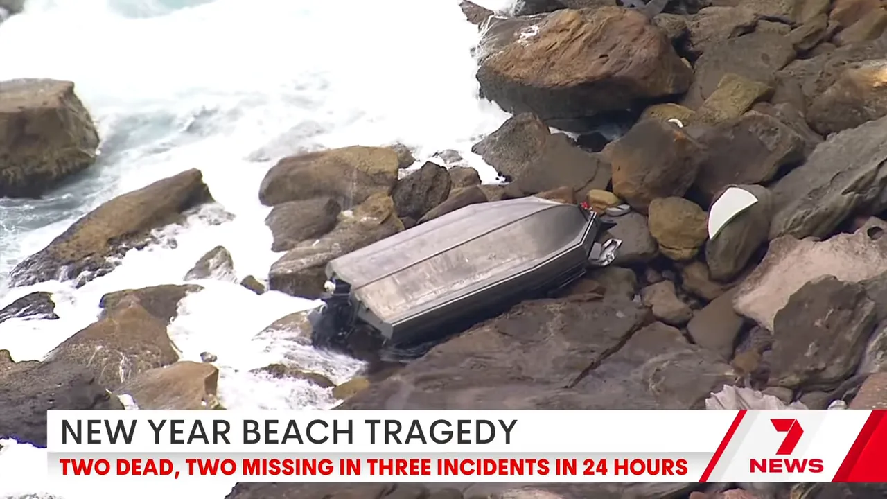 Capsized tinny washed up on rocky shoreline after a boat capsize