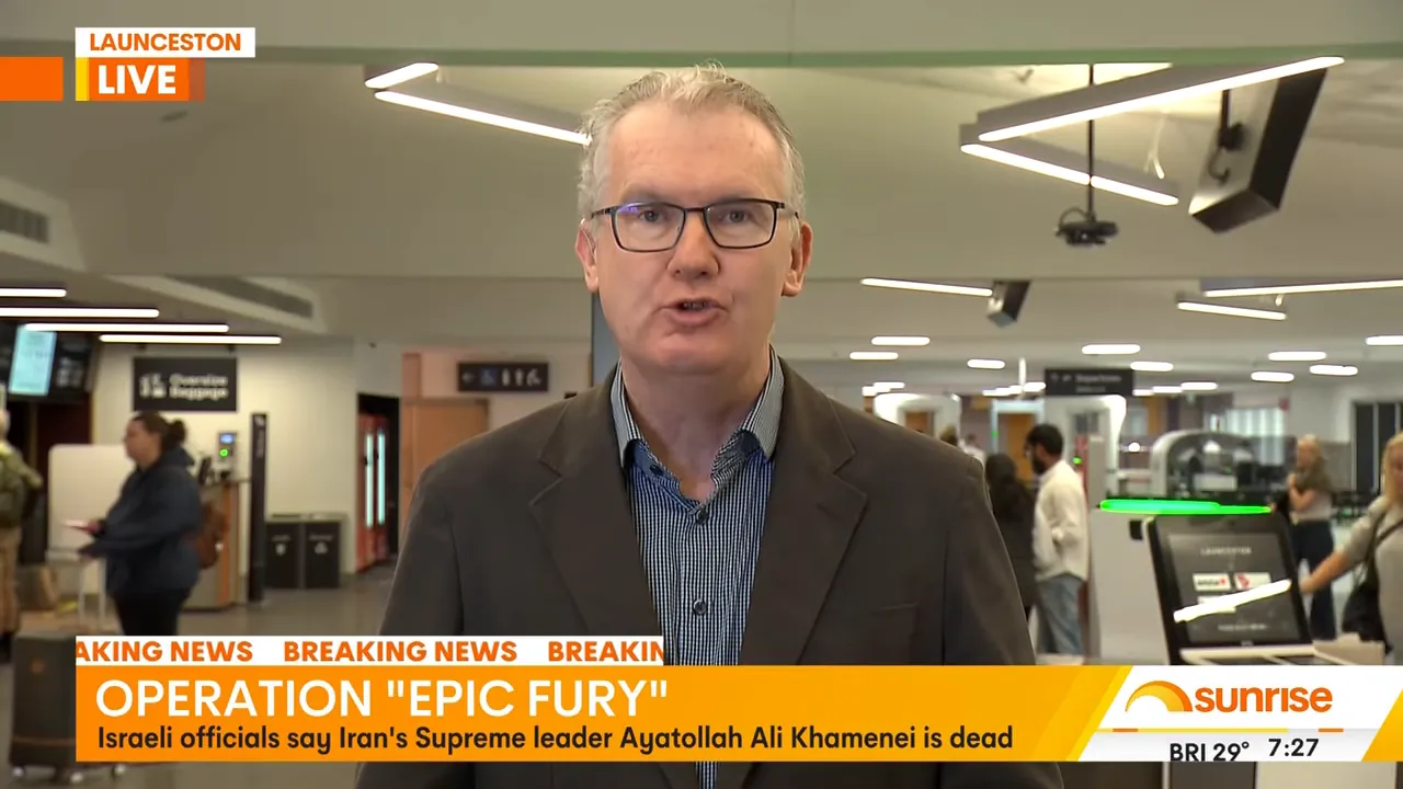 Television news shot of a reporter in an airport terminal with passengers and check-in kiosks behind and a breaking news headline about the strikes.