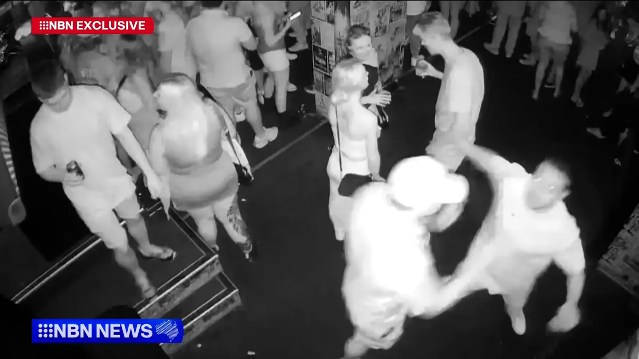 Two men pushing and shoving inside the nightclub, the incident beginning.