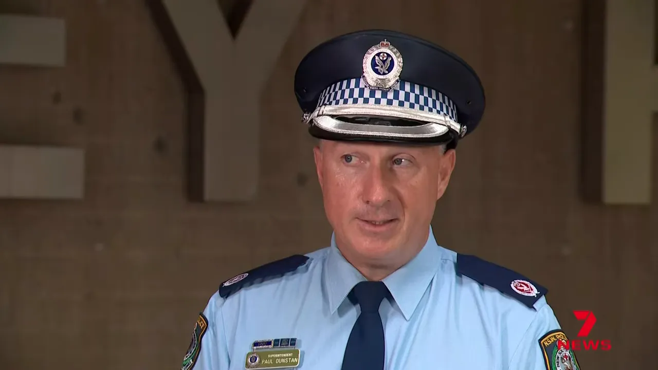 Senior uniformed police officer at a press briefing explaining public assembly restrictions, clear and well-lit