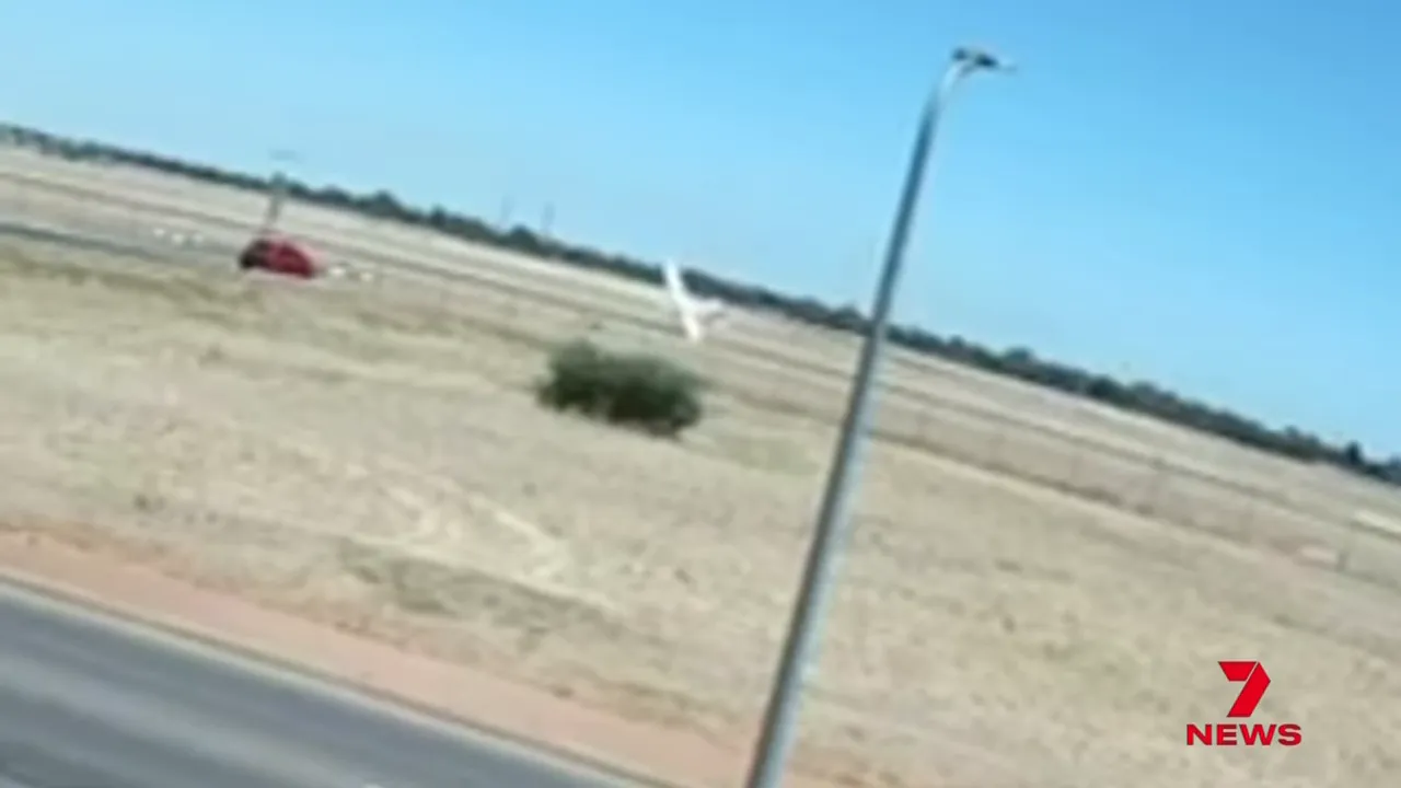 white Cessna training aircraft visible in field during failed touch-and-go at Parafield
