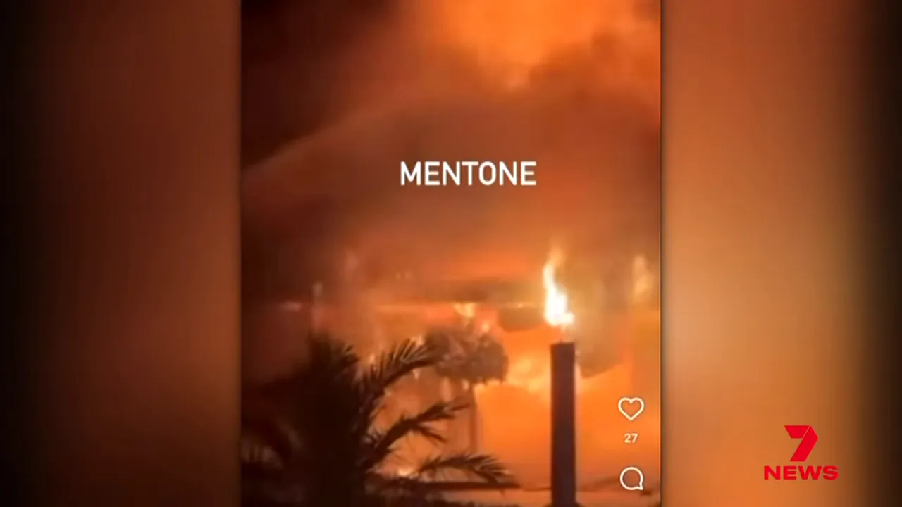 Smoke rising from the building as residents flee