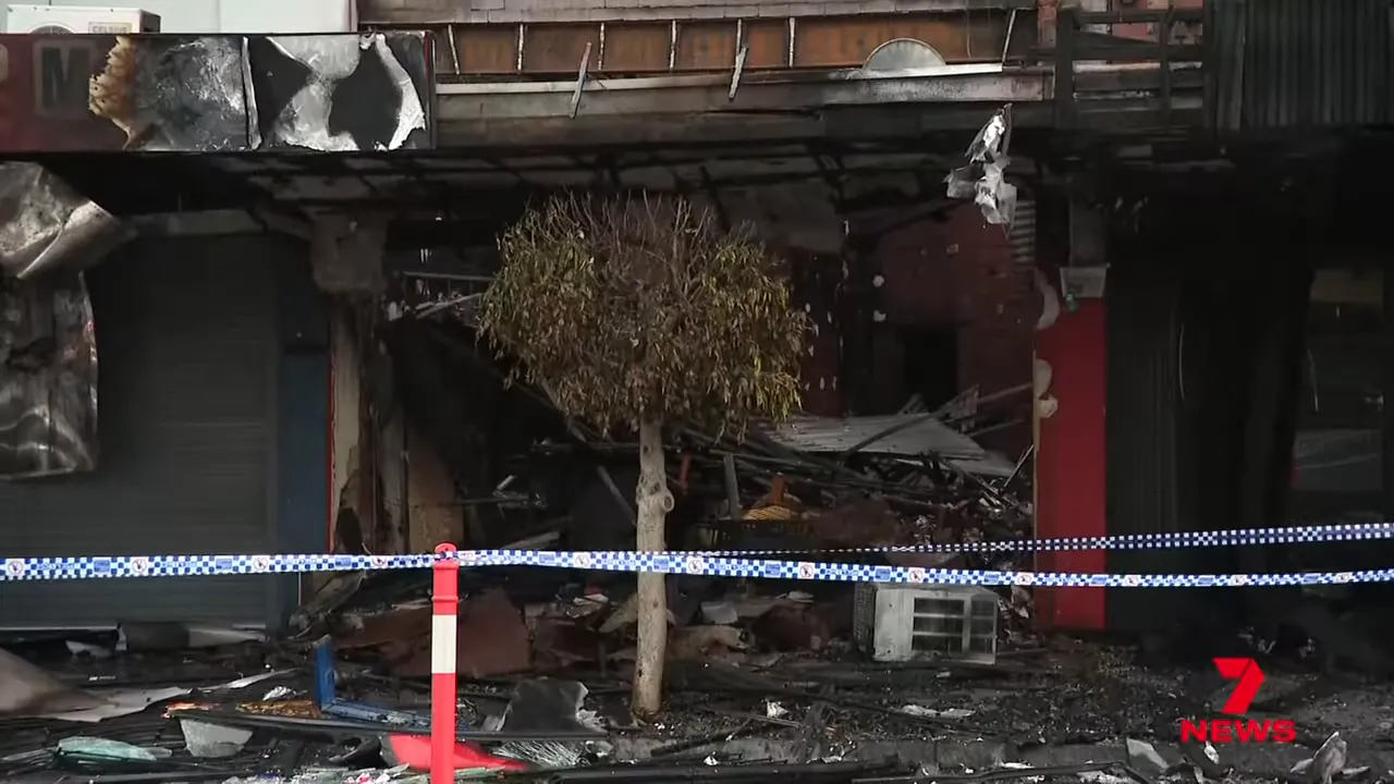 Damaged storefront after arsonists rammed the shop