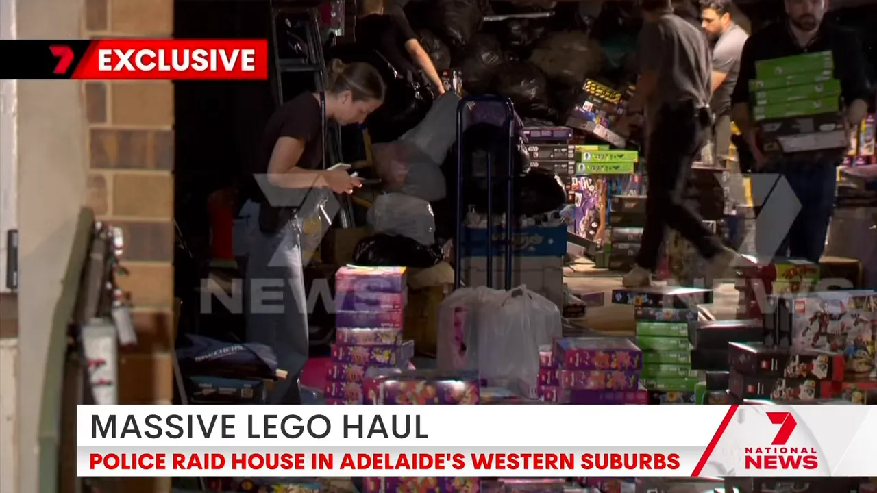 Police officers loading boxed Lego sets during the Adelaide Lego raid