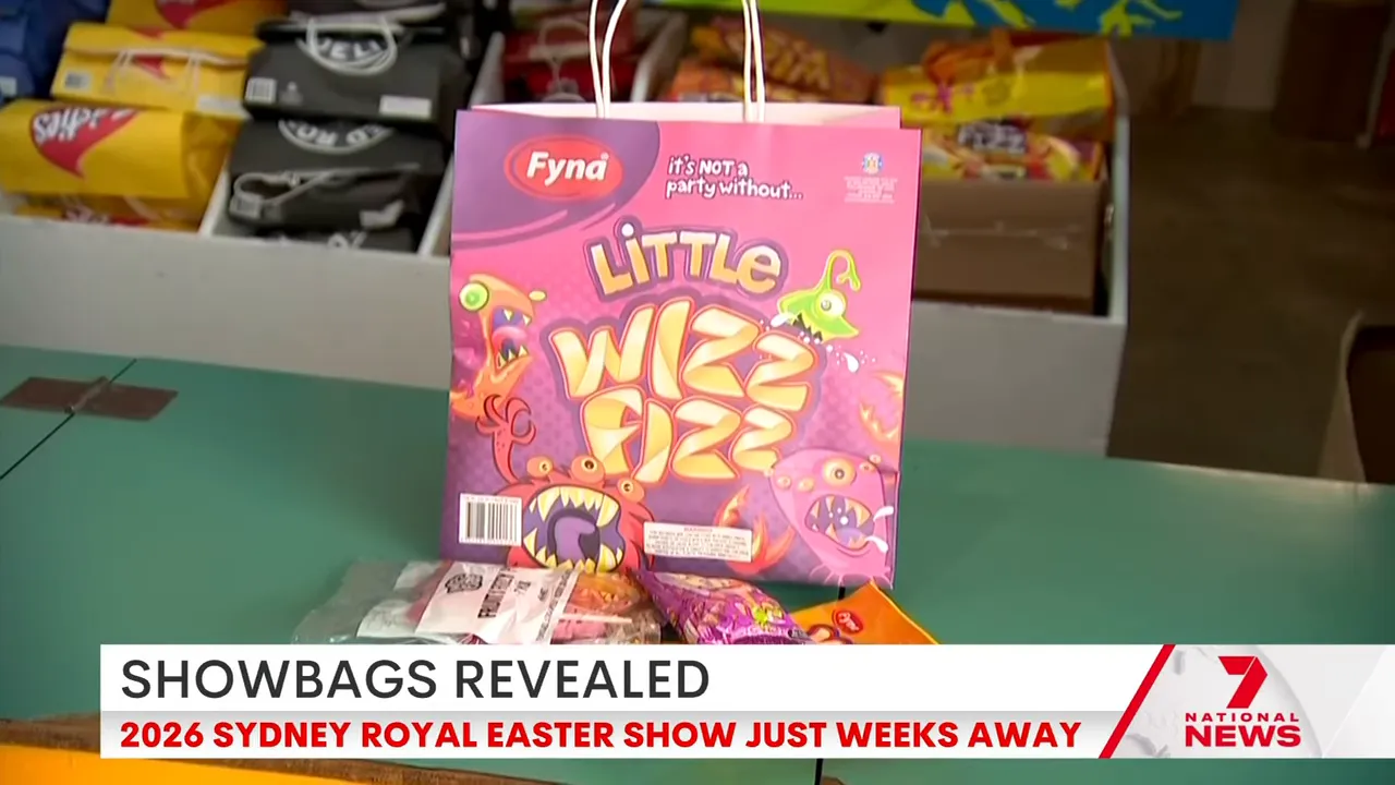 Pink 'Little Wizz Fizz' showbag on a counter with confectionery items in front
