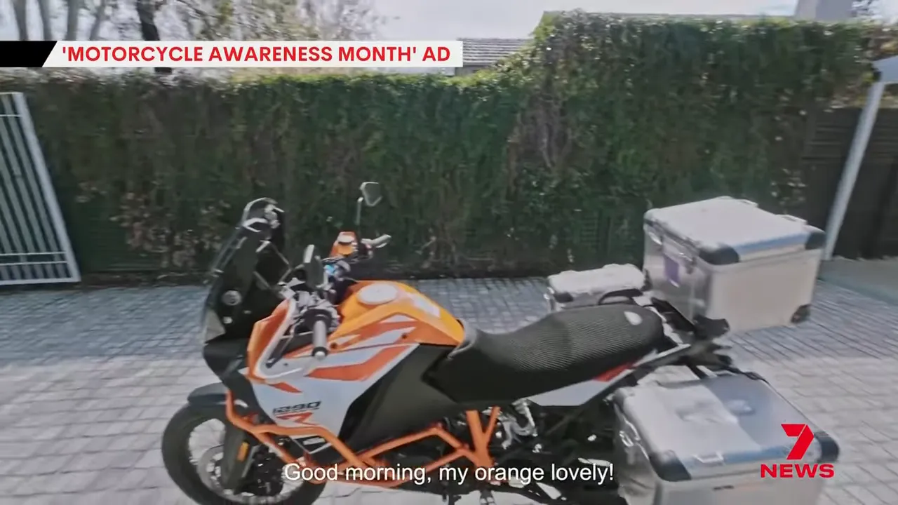 Ross Noble on his orange motorcycle greeting it