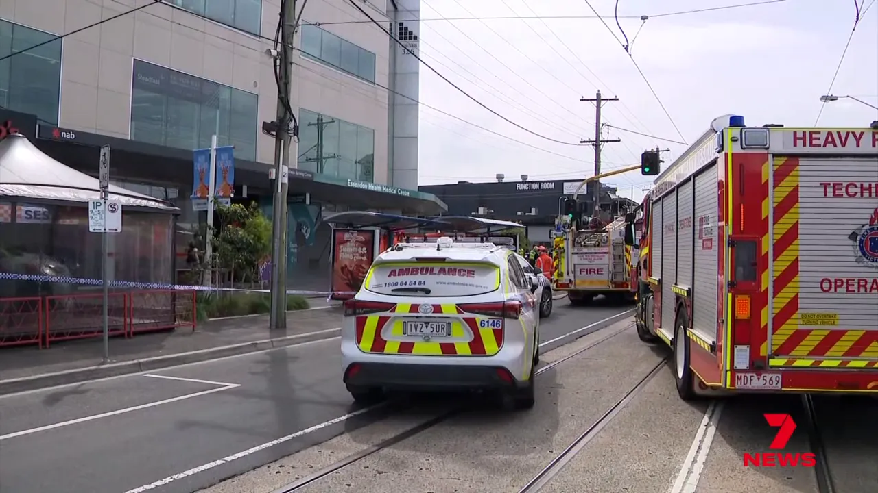 Ambulance and fire trucks stationed on the road outside Essendon Health Medical Centre