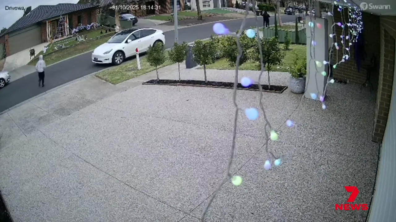 Street sign indicating Wyndham Vale and houses at twilight
