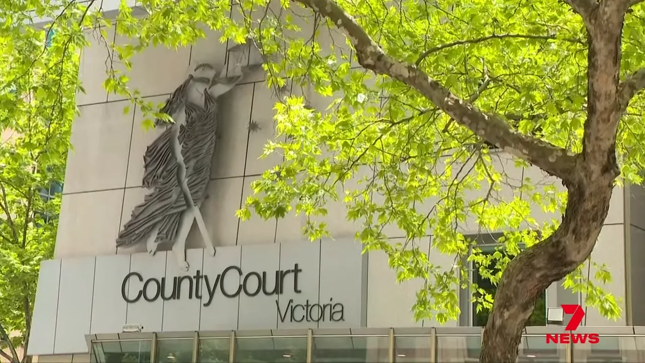 Exterior view of County Court Victoria building with signage and leafy trees