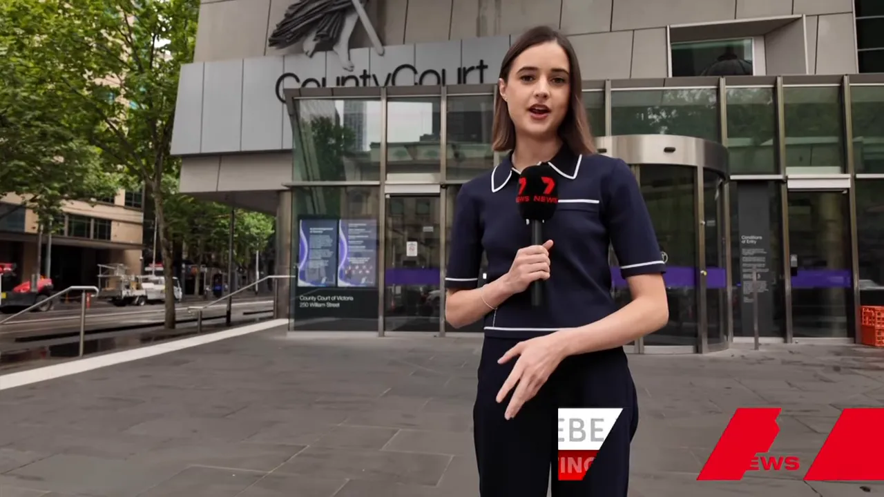 News reporter standing at the County Court entrance delivering a report, building signage visible behind her