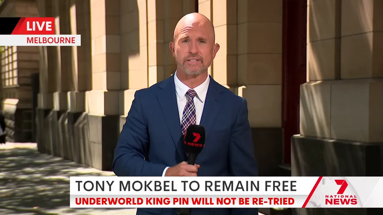 Television reporter delivering a live stand-up outside a courthouse with a breaking-news chyron visible.