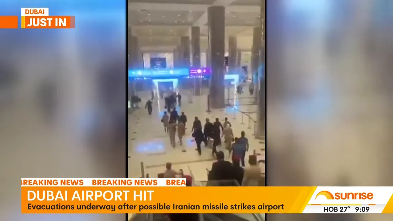 Clear shot of passengers walking through a Dubai airport terminal during evacuation