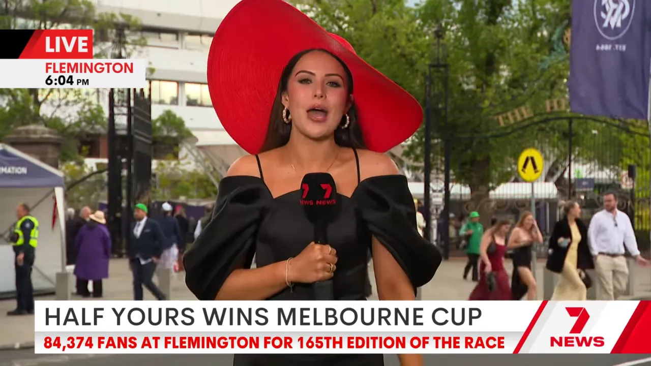 Attendee holding an umbrella under grey skies