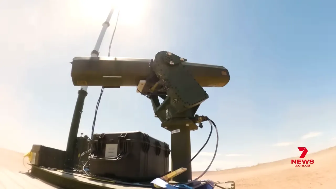 Ground‑mounted counter‑drone radar and sensor array on a desert test range, showing cabling and equipment cases.