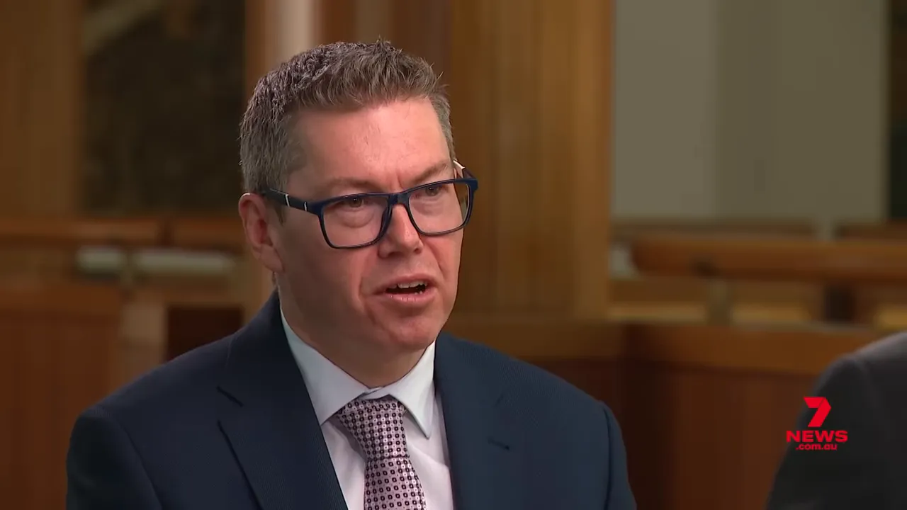 Close-up of the interview subject speaking emphatically in a formal studio interview.