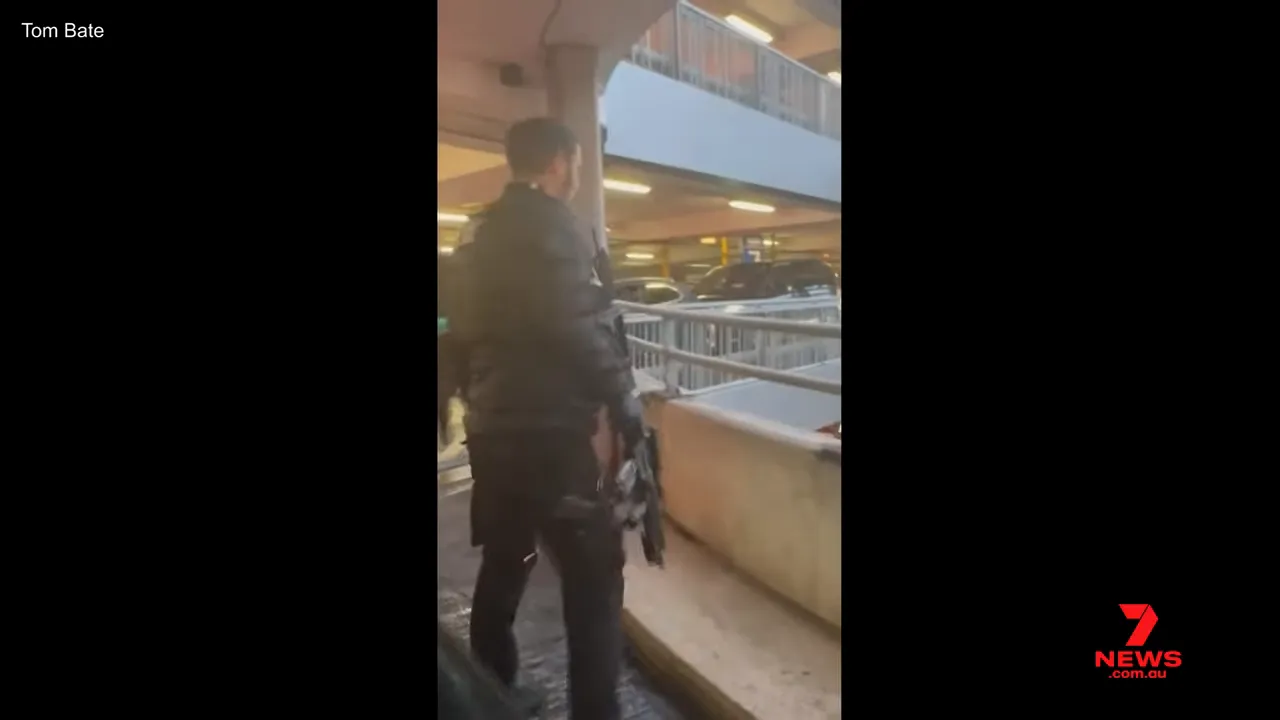 Heavily armed police officer running in Heathrow Terminal Three multi-storey car park
