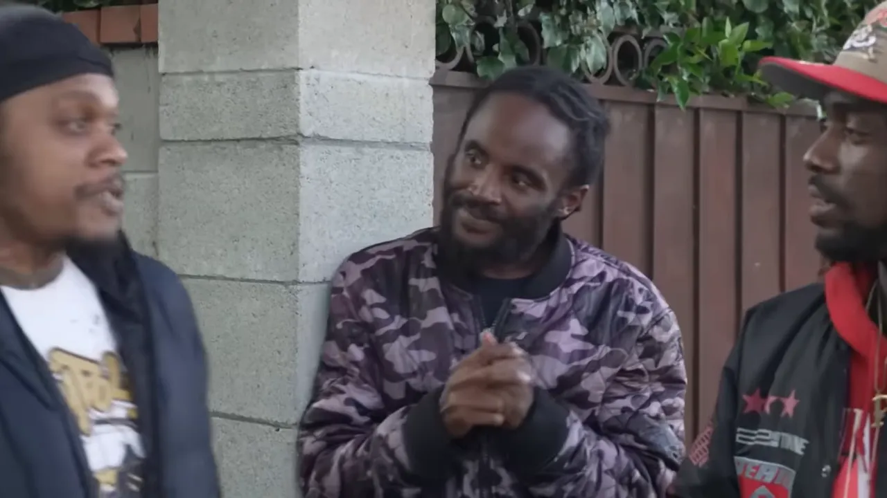 Street scene in Carson, with young men gathered on a block