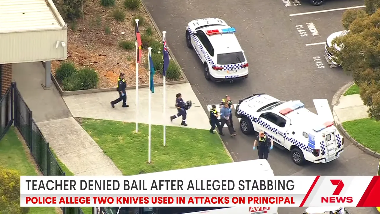 Aerial shot of police vehicles and officers outside a school during a lockdown