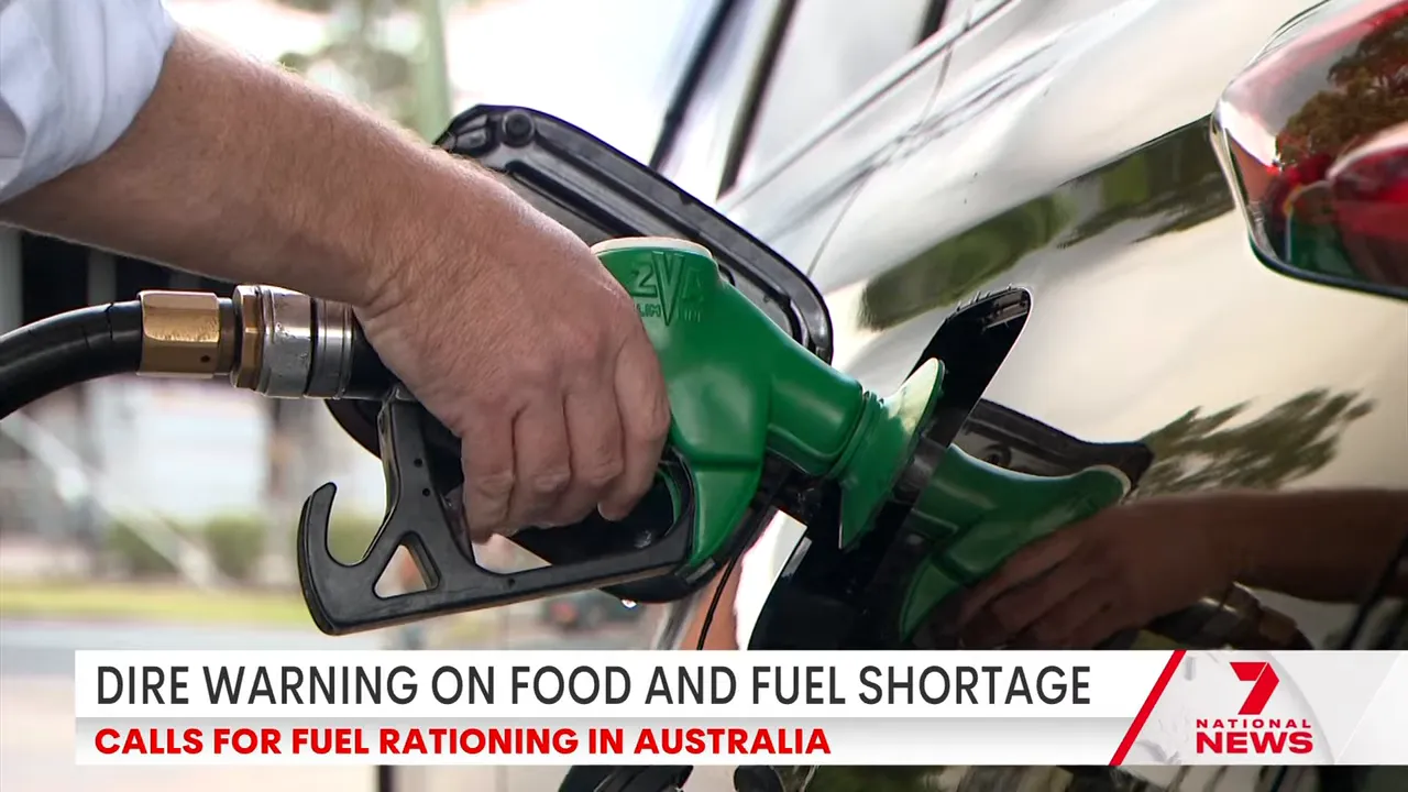 Hand refuelling a car at a petrol pump as Australia faces potential fuel rationing due to looming shortages