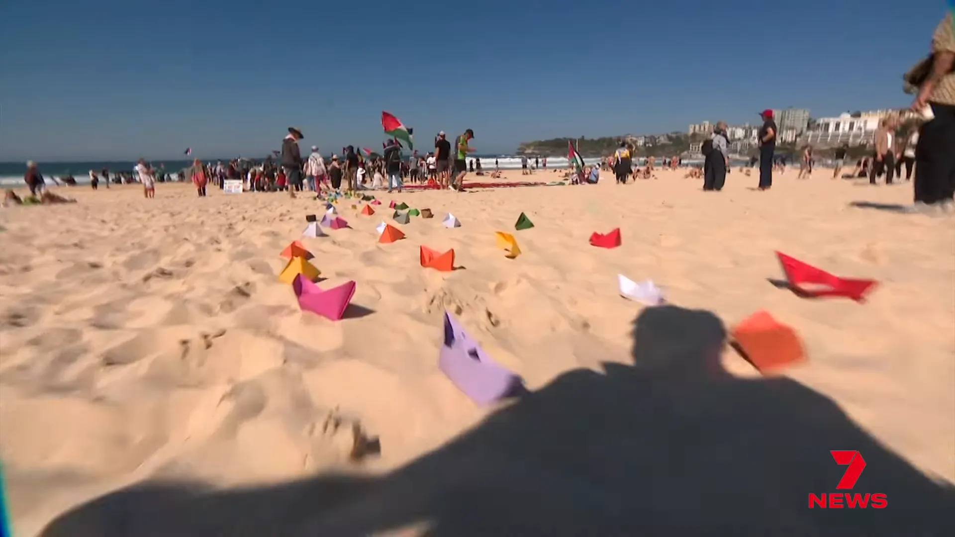 Origami boats released into the ocean during the paddle out